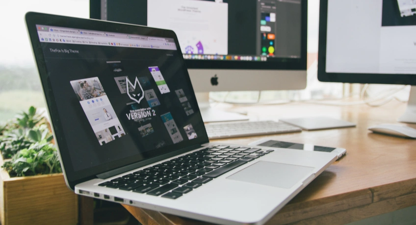 Alt Text: Business comparing an old website with a modern website redesign.